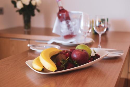 a plate of fruit on a wooden table at ON'LIVE HOTEL in Cesme
