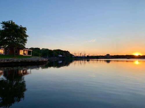 a view of a river with the sunset in the background at Harbor View Landing in Mystic