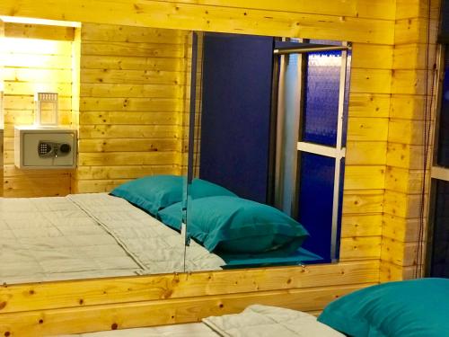 a bedroom with a bed with a window in it at Blu Cabin Ari Stylish Gay Poshtel in Bangkok
