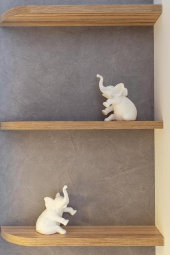 two white vases sitting on a wooden shelf at Atlantis ''Pleasure by the Sea'' in Perea