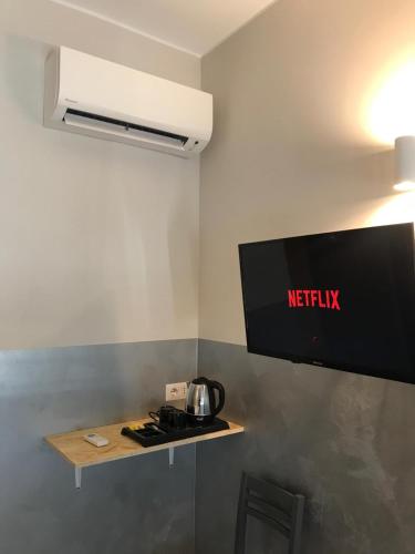 a tv on a wall in a room at Bergamo GuestHouse - Self Check-in in Curno