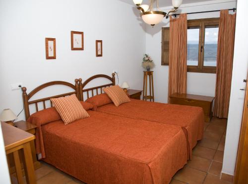 A bed or beds in a room at Casa Rural SPA El Rincón de Palmacio