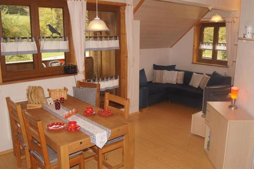 a kitchen and living room with a table and a couch at Biohof Schad in Eisenbach