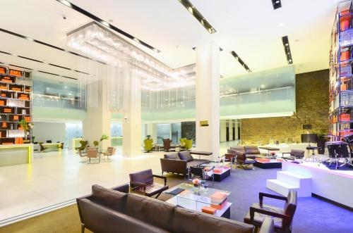 a lobby with couches and chairs in a building at Midas Hotel and Casino in Manila