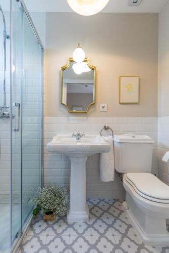 a bathroom with a sink and a toilet and a mirror at Alquería Calatrava B&B in Burriana