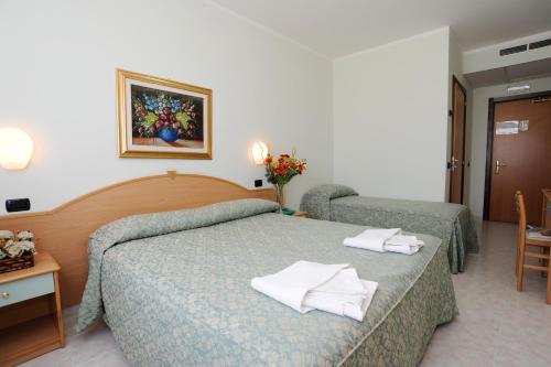 a hotel room with a bed with towels on it at Hotel Garden in San Giovanni Rotondo