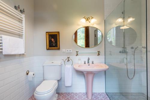 a bathroom with a sink and a toilet and a mirror at Alquería Calatrava B&B in Burriana