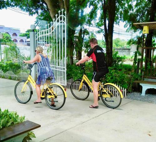 a man and a woman on a yellow bike at Mango House in Sukhothai