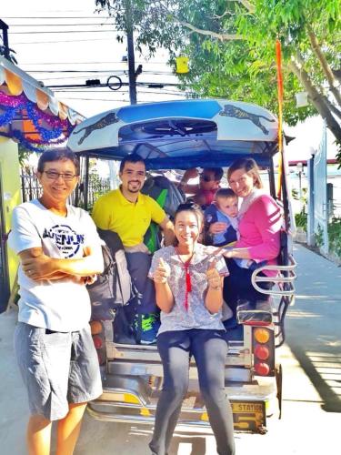 a group of people standing in the back of a trolley at Mango House in Sukhothai