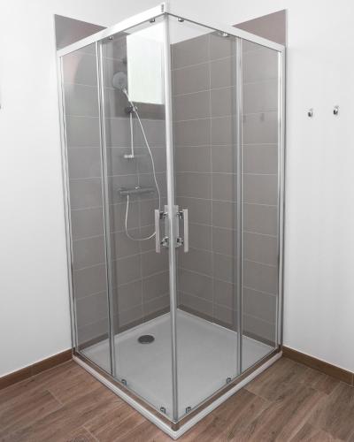 a shower with a glass enclosure in a room at Au chalet des quatre saisons in Ax-les-Thermes