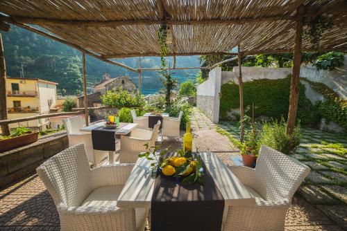 a table and chairs on a patio with a view at Aquarius Maiori B&B in Maiori