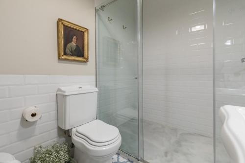 a bathroom with a toilet and a glass shower at Alquería Calatrava B&B in Burriana