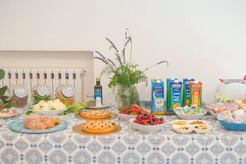 a table topped with plates of food and snacks at Aquarius Maiori B&B in Maiori