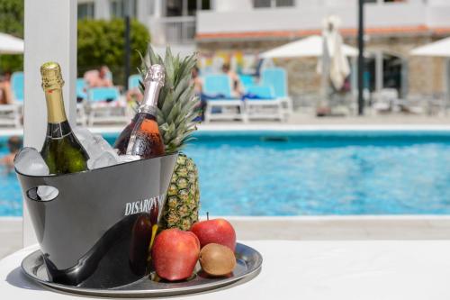 a bucket of wine and fruit next to a pool at Hotel Vibra Marco Polo I - Adults only in San Antonio