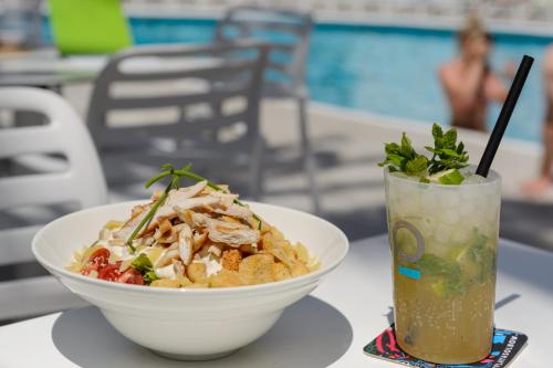 a bowl of food and a drink on a table at Hotel Vibra Marco Polo I - Adults only in San Antonio
