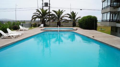 ein großer blauer Swimmingpool neben einem Gebäude in der Unterkunft Edificio Doña Anita Dpto 906 in La Serena