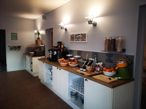 a kitchen with a counter with fruit on it at Hôtel Le Vert Bois in Dolus d'Oléron