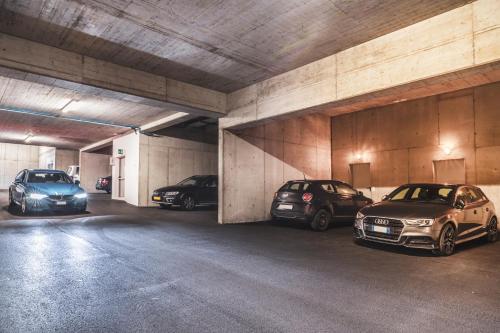 a group of three cars parked in a parking garage at Hidalgo Suites in Postal