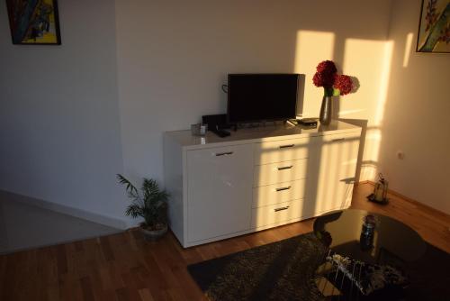 a white dresser with a television on top of it at APP LU 5 in Novi Vinodolski