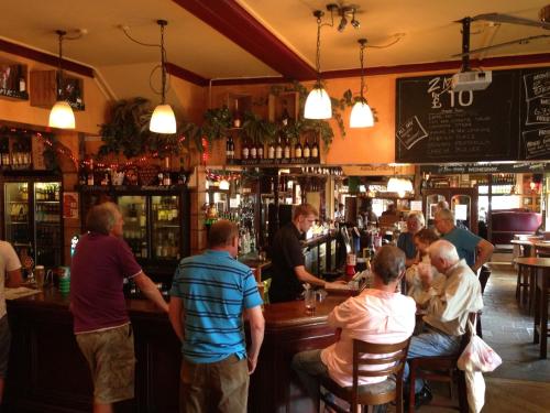 a group of people sitting at a bar at The Junction Hotel in Dorchester