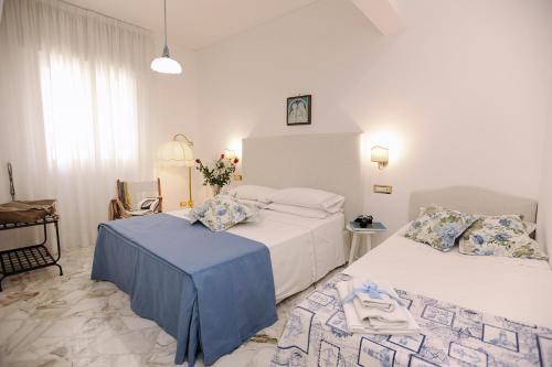 Posteľ alebo postele v izbe v ubytovaní La Kenzia Casa Vacanze