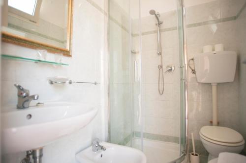a bathroom with a sink and a toilet and a shower at Villa Silvie Rose in Cesenatico