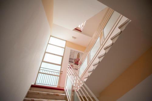 a staircase in a house with a window at Villa Silvie Rose in Cesenatico