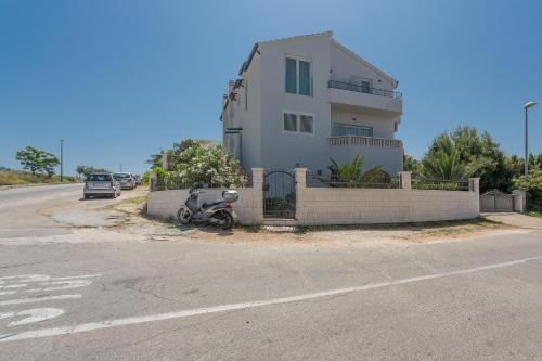 a motorcycle is parked in front of a house at Hvar Top View Apartments in Hvar