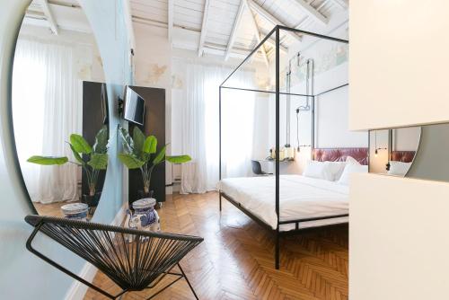 a room with a bed and a chair in it at The Trilogy House in Thessaloniki