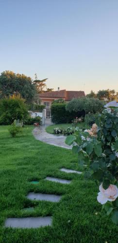a garden with stepping stones in the grass at Villa Luce B&B in Olbia