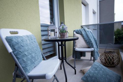 a patio with two chairs and a table on a balcony at Apartman LUNA in Trebinje