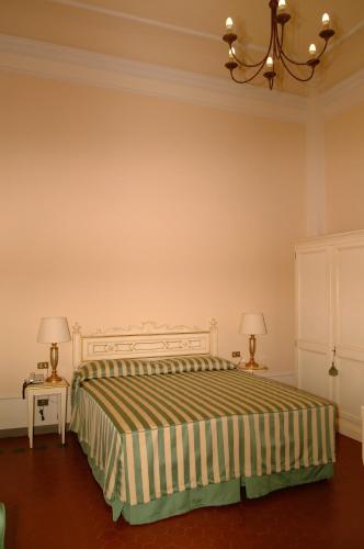 a bedroom with a bed and two lamps on tables at Residence Michelangiolo in Florence