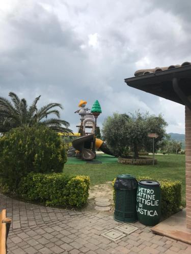 a playground with a slide in a park at Le case della baracchina in Pisa