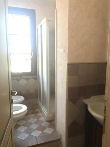 a bathroom with two toilets and a sink at Le case della baracchina in Pisa