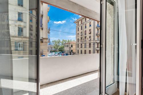 a window with a view of a city street at Affittacamere My Home in La Spezia