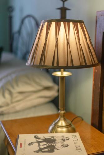 a lamp sitting on a table next to a book at Golden Eagle in Chester