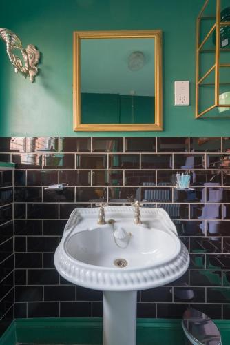 a bathroom with a white sink and a mirror at Golden Eagle in Chester