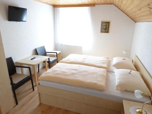 a bedroom with a bed and a table and a window at Rooms-Apartment Renata in Bled