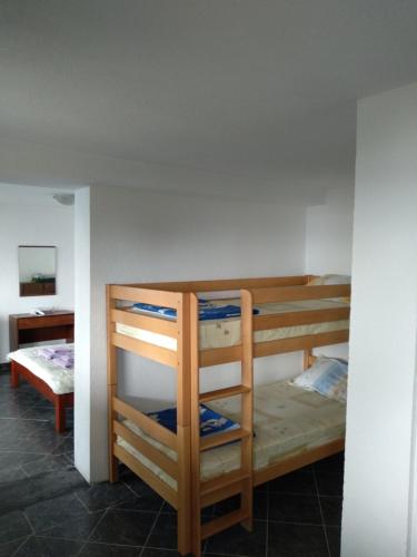 a room with two bunk beds and a desk at Villa Two Brothers in Ohrid