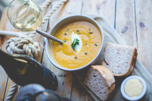 a bowl of soup with bread and a glass of wine at Beamish Hall Hotel, BW Premier Collection in Stanley