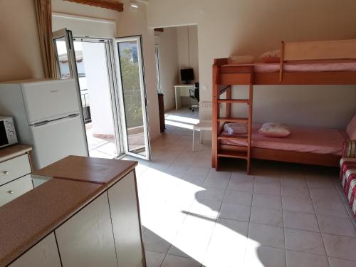 a kitchen with two bunk beds in a room at NEON Apartment, spacious, fully equipped, high-quality Apt with balcony, Messara Plain, south Crete in Vayioniá