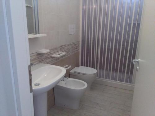 a bathroom with a toilet and a sink at Al Saliceto Hotel in Patti