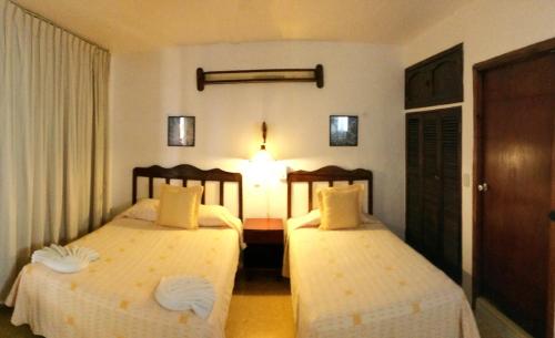 a hotel room with two beds in a room at Hotel Cozumel Costa Brava in Cozumel