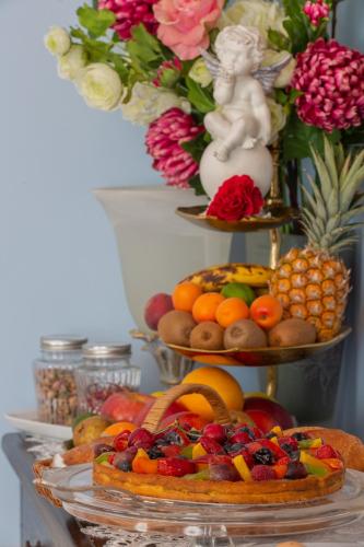 a display of fruits and vegetables on three tiers at Maison d'hôtes de charme La Rose de Ducey près du Mont Saint Michel in Ducey
