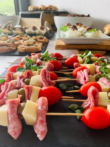 a table topped with cheese and meats and tomatoes at Mont d'Or Monte Bello Estate in Bloemfontein