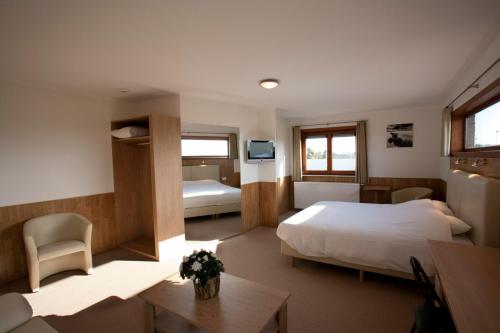 ein Hotelzimmer mit einem Bett und einem Schreibtisch in der Unterkunft Hotel Chamdor in Roeselare
