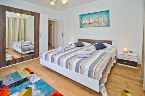 a bedroom with a large bed and a mirror at Sweet Dreams in Hvar