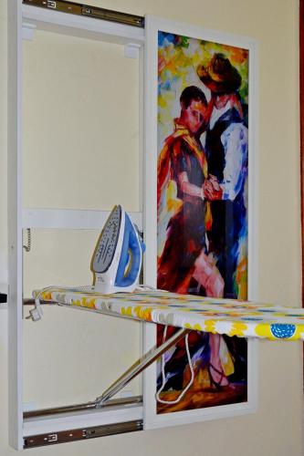 a painting of a couple and a surfboard in a room at Boutique Hotel Eco-House Tbilisi in Tbilisi City