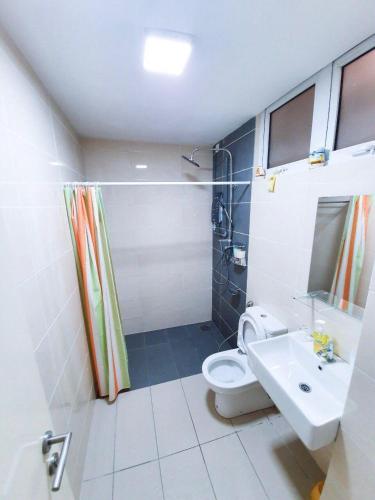 a bathroom with a toilet and a shower and a sink at Yenni Duplex @ DeCentrum, Kajang in Seri Kembangan