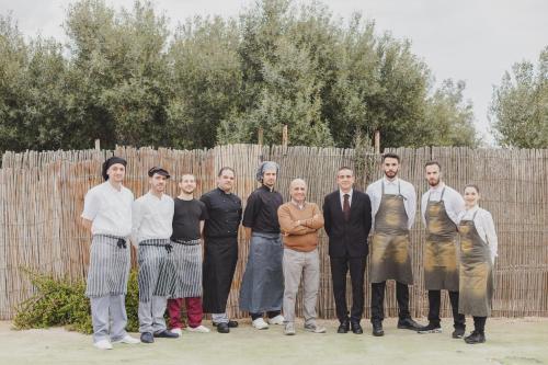 a group of people standing in front of a fence at LOCANDA VECCHIA FATTORIA in Monserrato